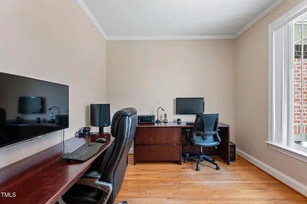 a view of workspace with wooden floor windows