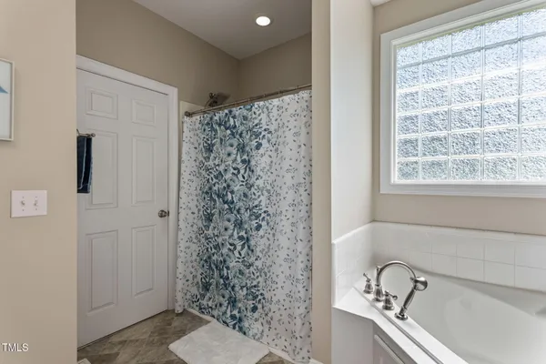 a view of walk in closet with clothes