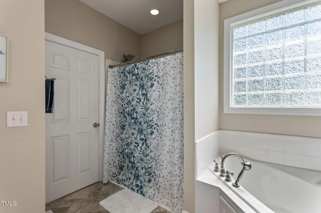 a view of walk in closet with clothes