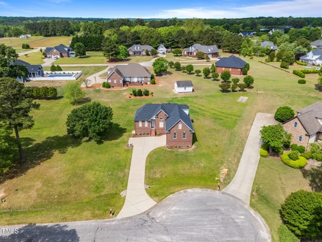 a swimming pool with outdoor seating and yard