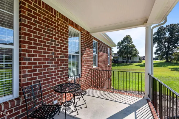 a view of a patio with a table chairs and garden