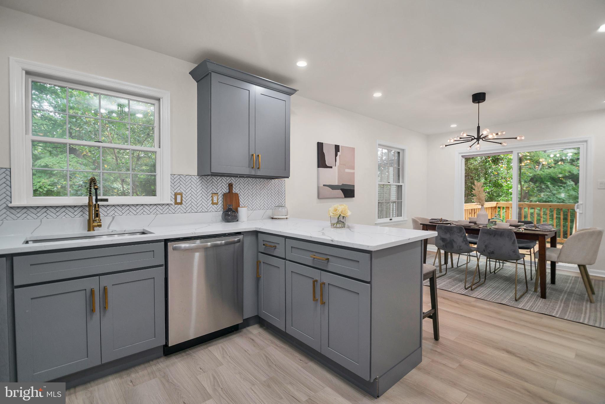 5809 Shana Place Burke, VA 22015 - Photo 15 of 46 a kitchen with a sink window and cabinets