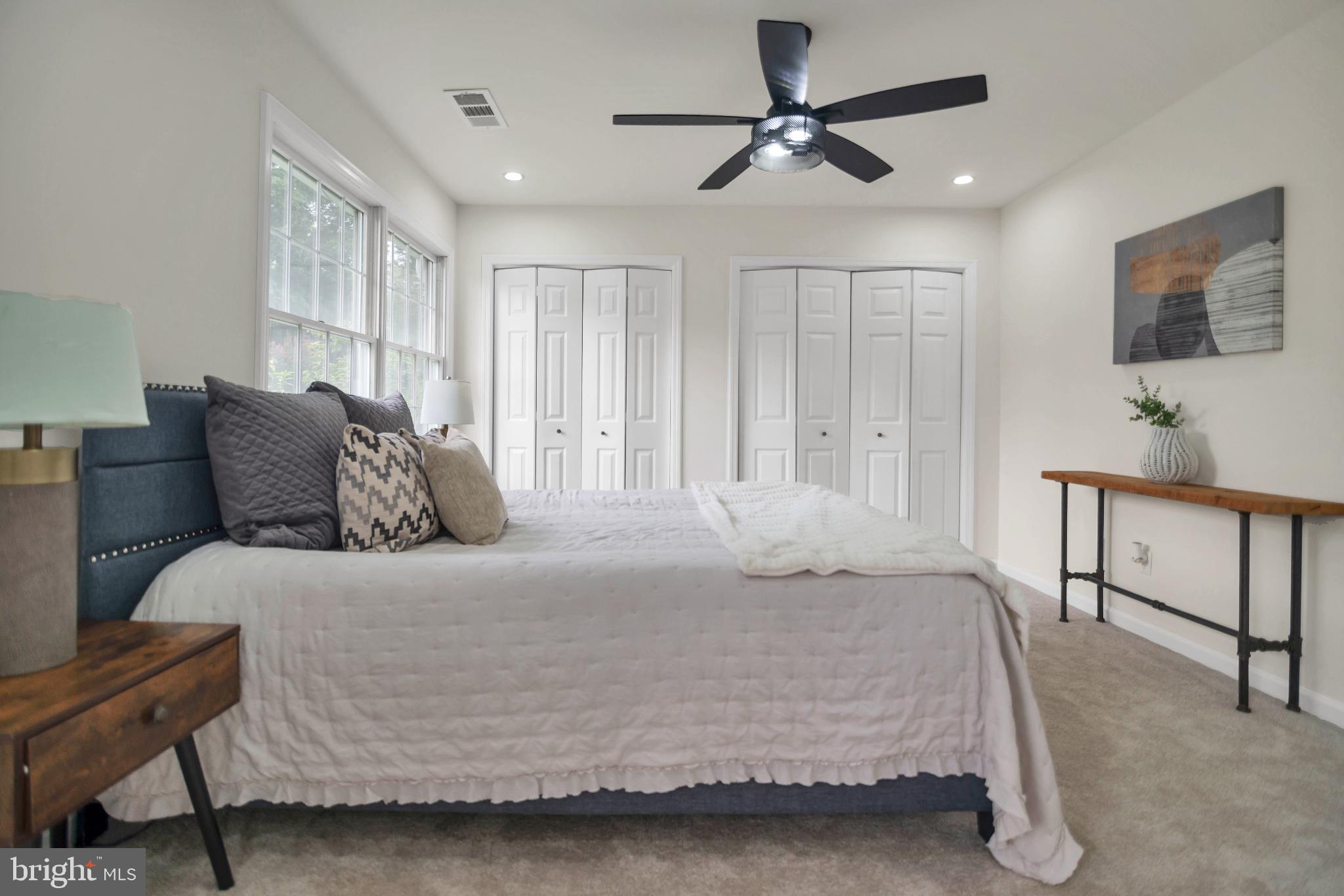 5809 Shana Place Burke, VA 22015 - Photo 24 of 46 a bedroom with a bed a chandelier and a dresser