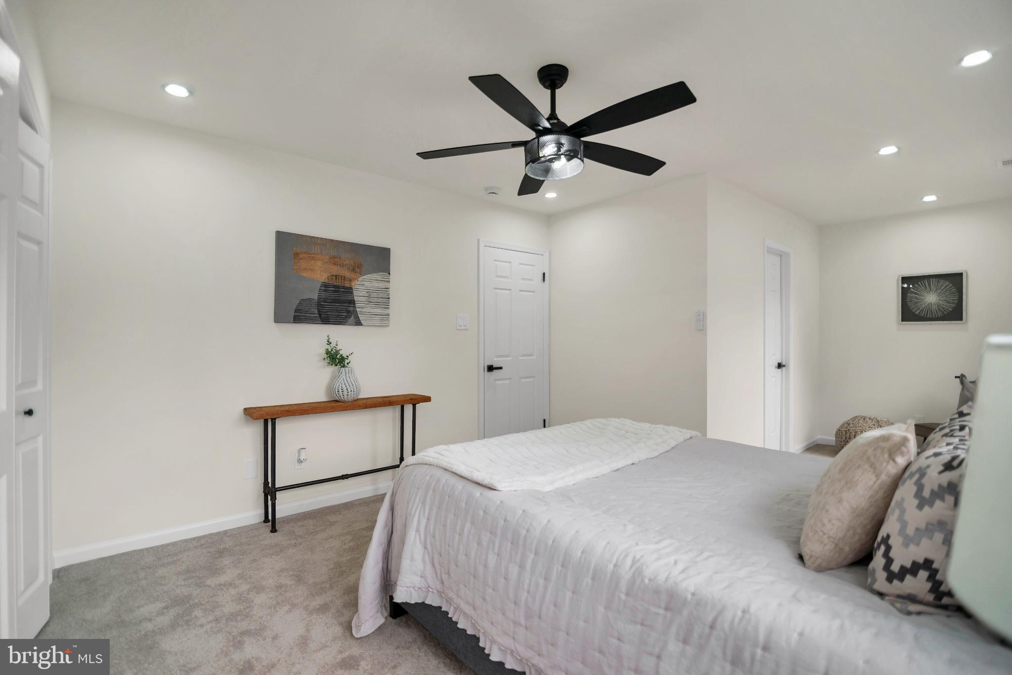 5809 Shana Place Burke, VA 22015 - Photo 26 of 46 a bedroom with a bed and a chandelier