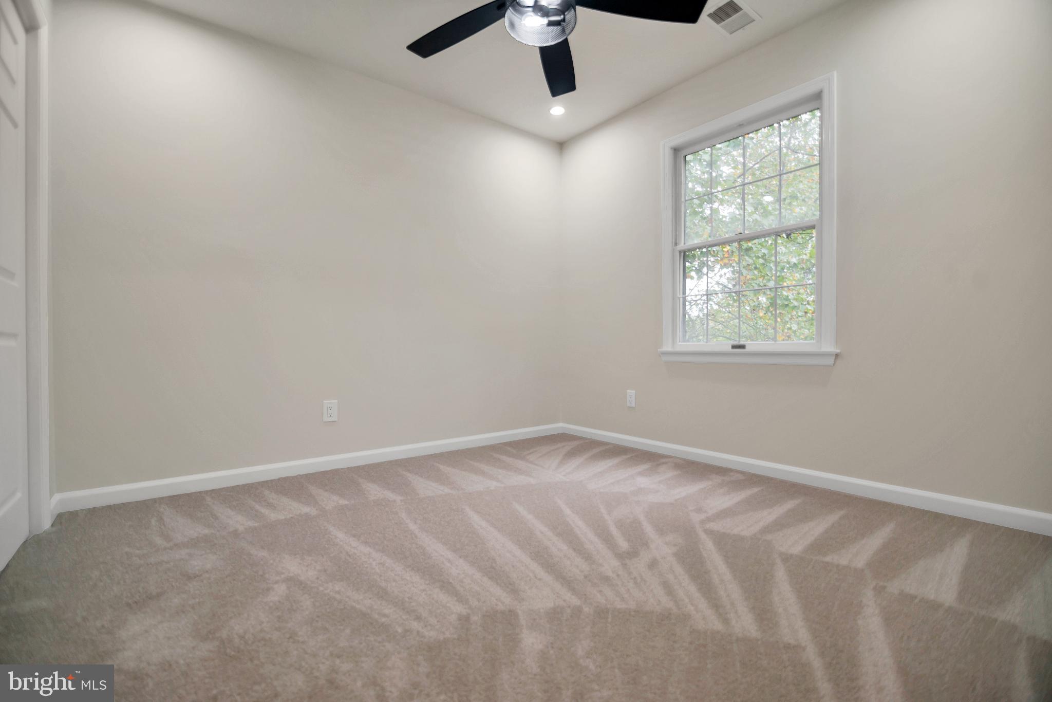 5809 Shana Place Burke, VA 22015 - Photo 32 of 46 an empty room with a window and a fan