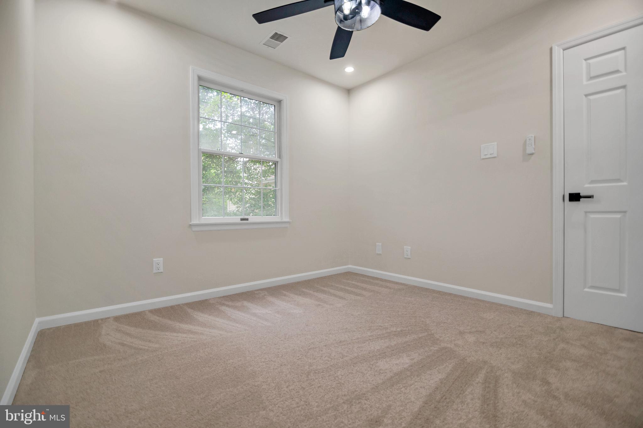 5809 Shana Place Burke, VA 22015 - Photo 33 of 46 an empty room with chandelier fan and windows