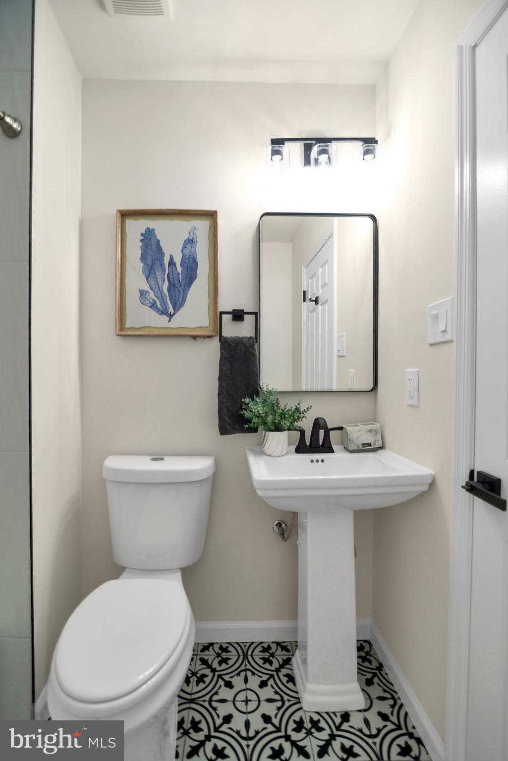 5809 Shana Place Burke, VA 22015 - Photo 34 of 46 a bathroom with a sink toilet and mirror