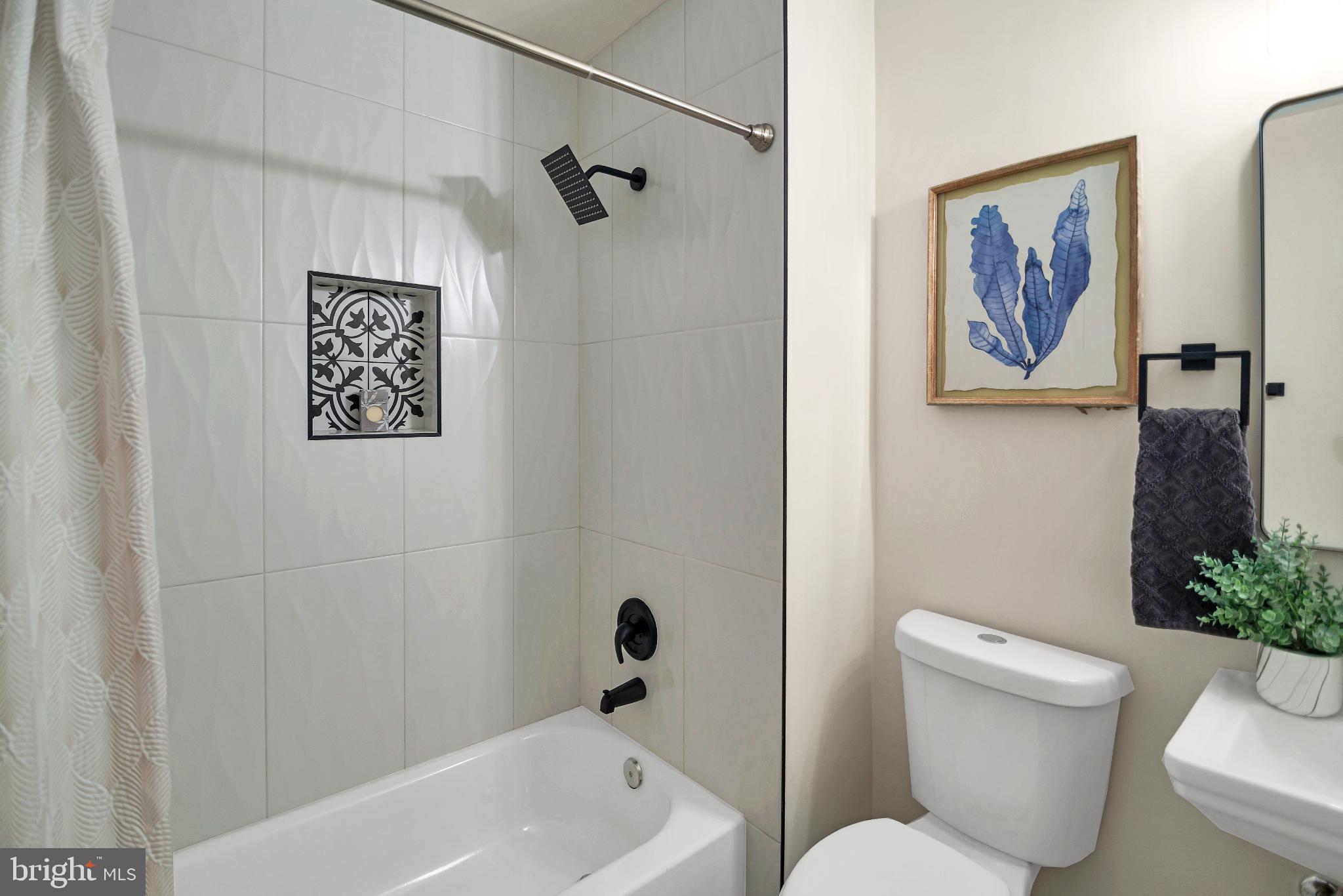 5809 Shana Place Burke, VA 22015 - Photo 35 of 46 a bathroom with a toilet and a bathtub