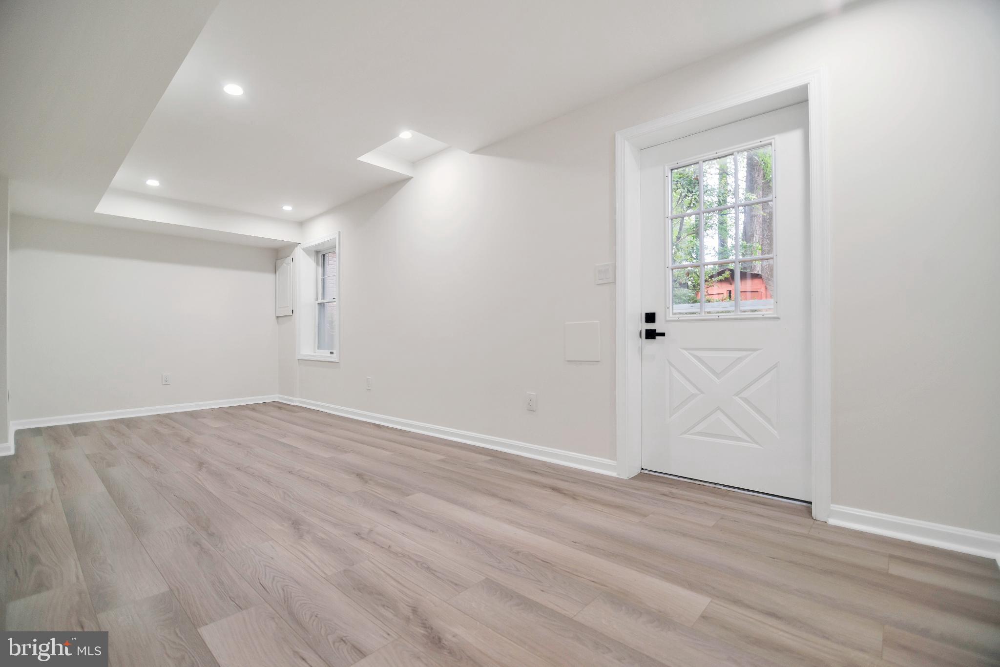 5809 Shana Place Burke, VA 22015 - Photo 39 of 46 an empty room with wooden floor and windows