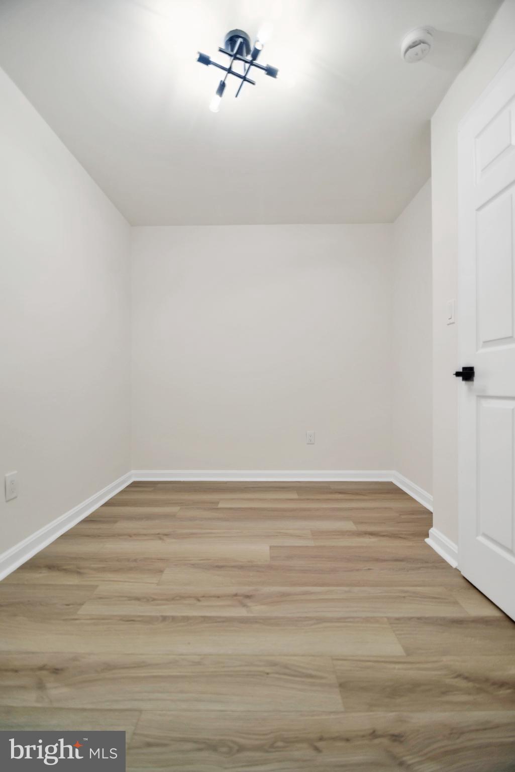 5809 Shana Place Burke, VA 22015 - Photo 40 of 46 a view of a room with wooden floor
