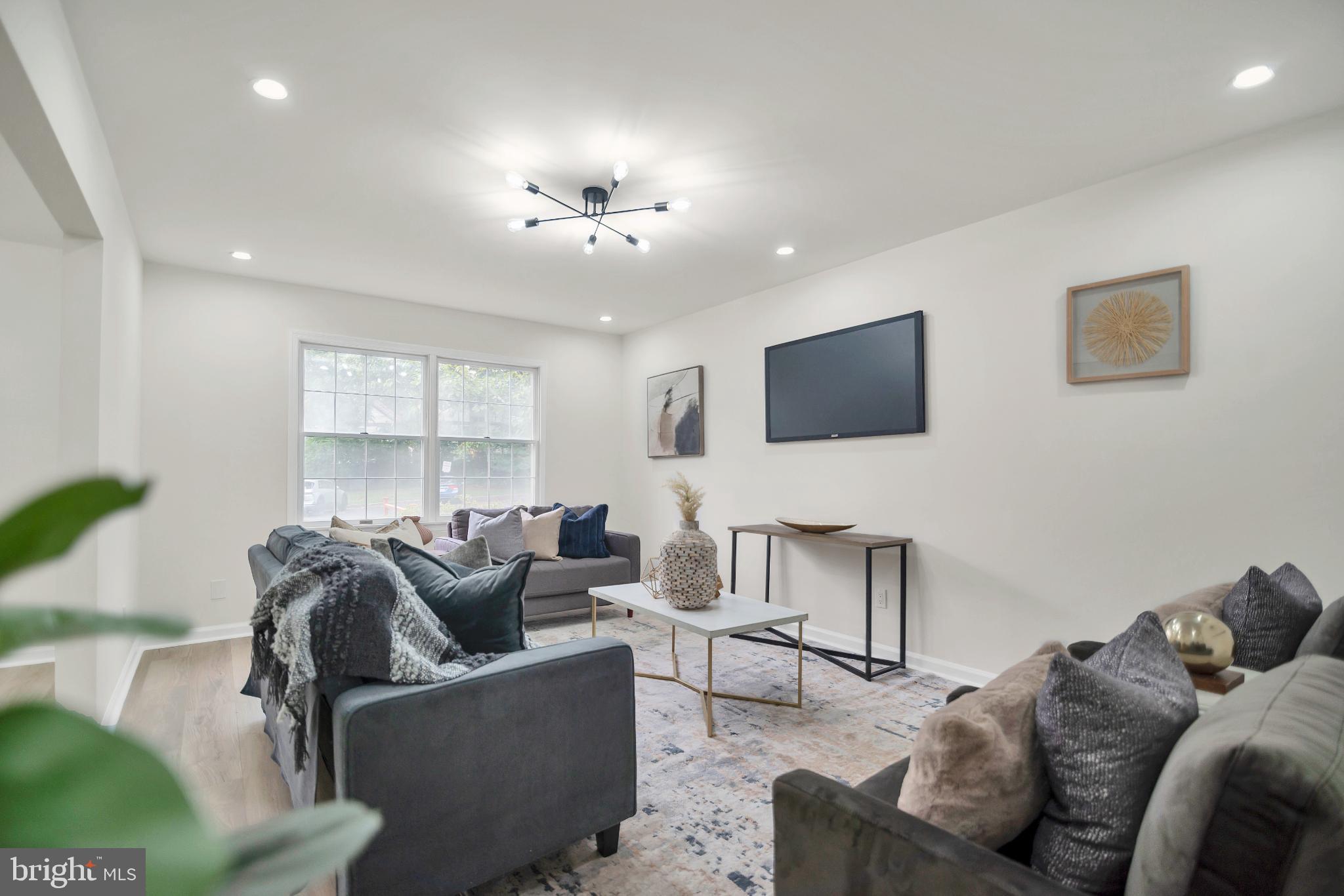 5809 Shana Place Burke, VA 22015 - Photo 6 of 46 a living room with furniture and a flat screen tv