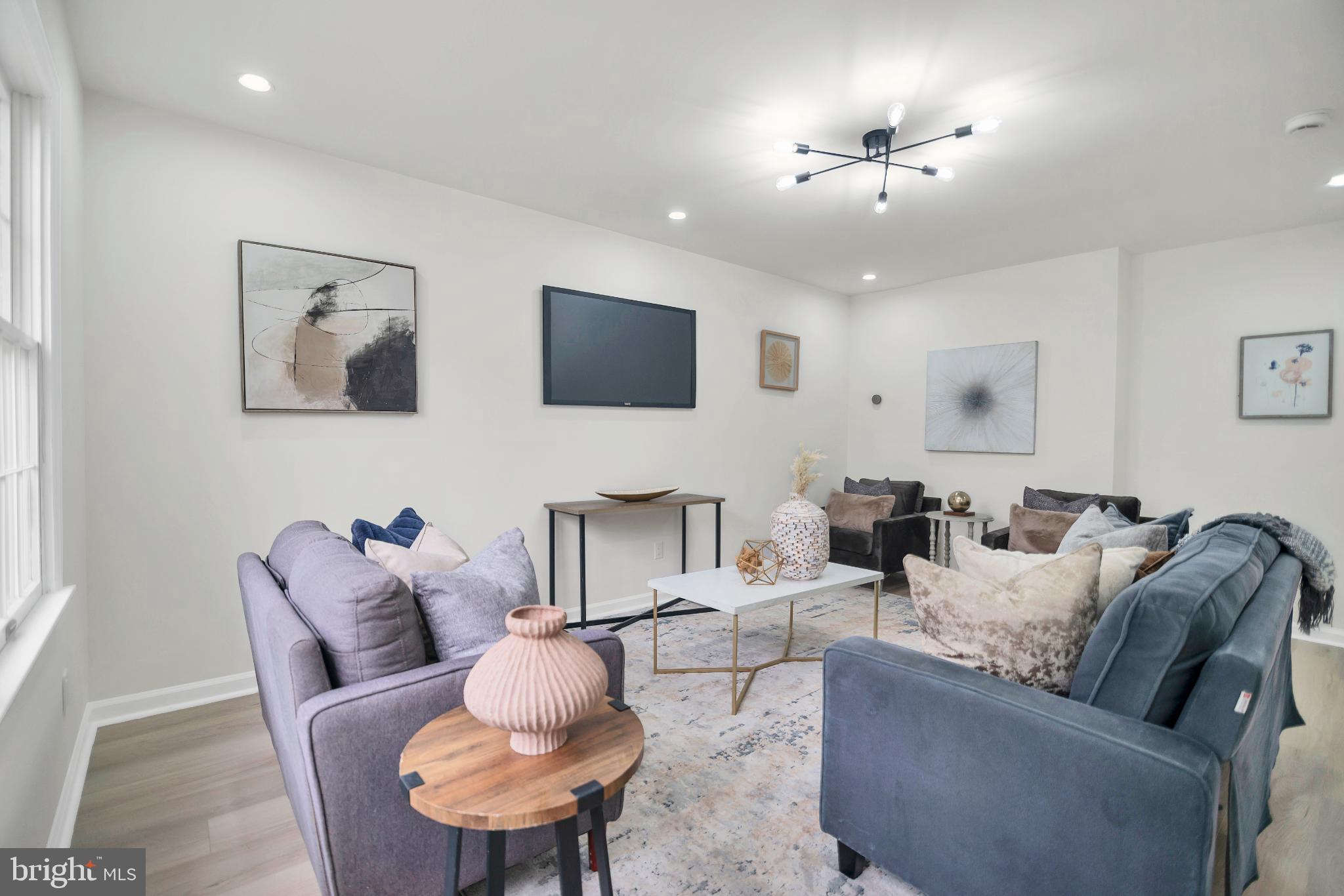 5809 Shana Place Burke, VA 22015 - Photo 7 of 46 a living room with furniture and a flat screen tv