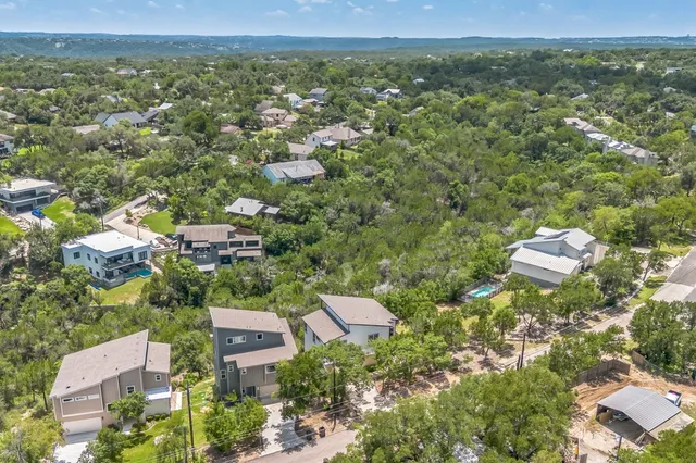 an aerial view of a house with a yard and potted plants