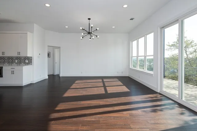 a kitchen with stainless steel appliances granite countertop a stove a sink and a wooden floors