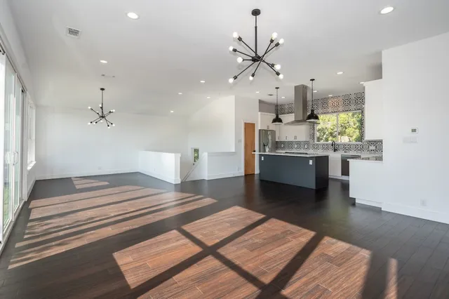 a spacious bathroom with a sink and a mirror