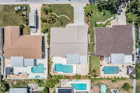 an aerial view of residential building with green space