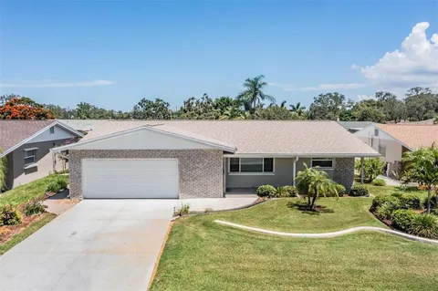 a terrace with outdoor seating and trees