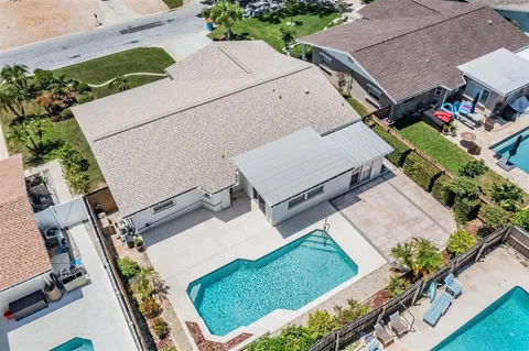 an aerial view of a house with a garden and mountain view