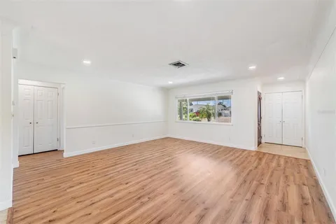 a view of an empty room and wooden floor