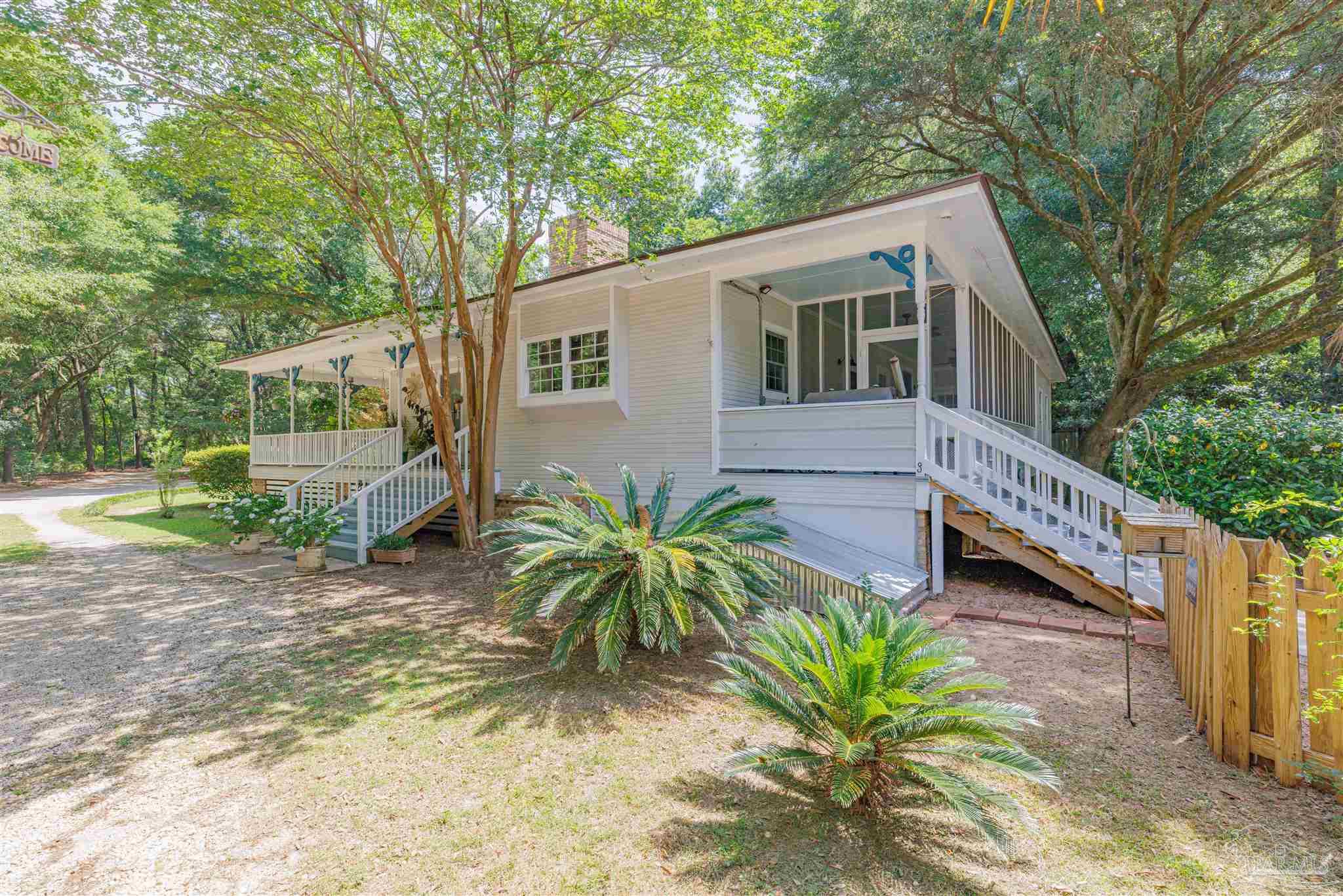 5049 Guernsey Road Pace, FL 32571 - Photo 54 of 61 a view of a house with a yard and potted plants