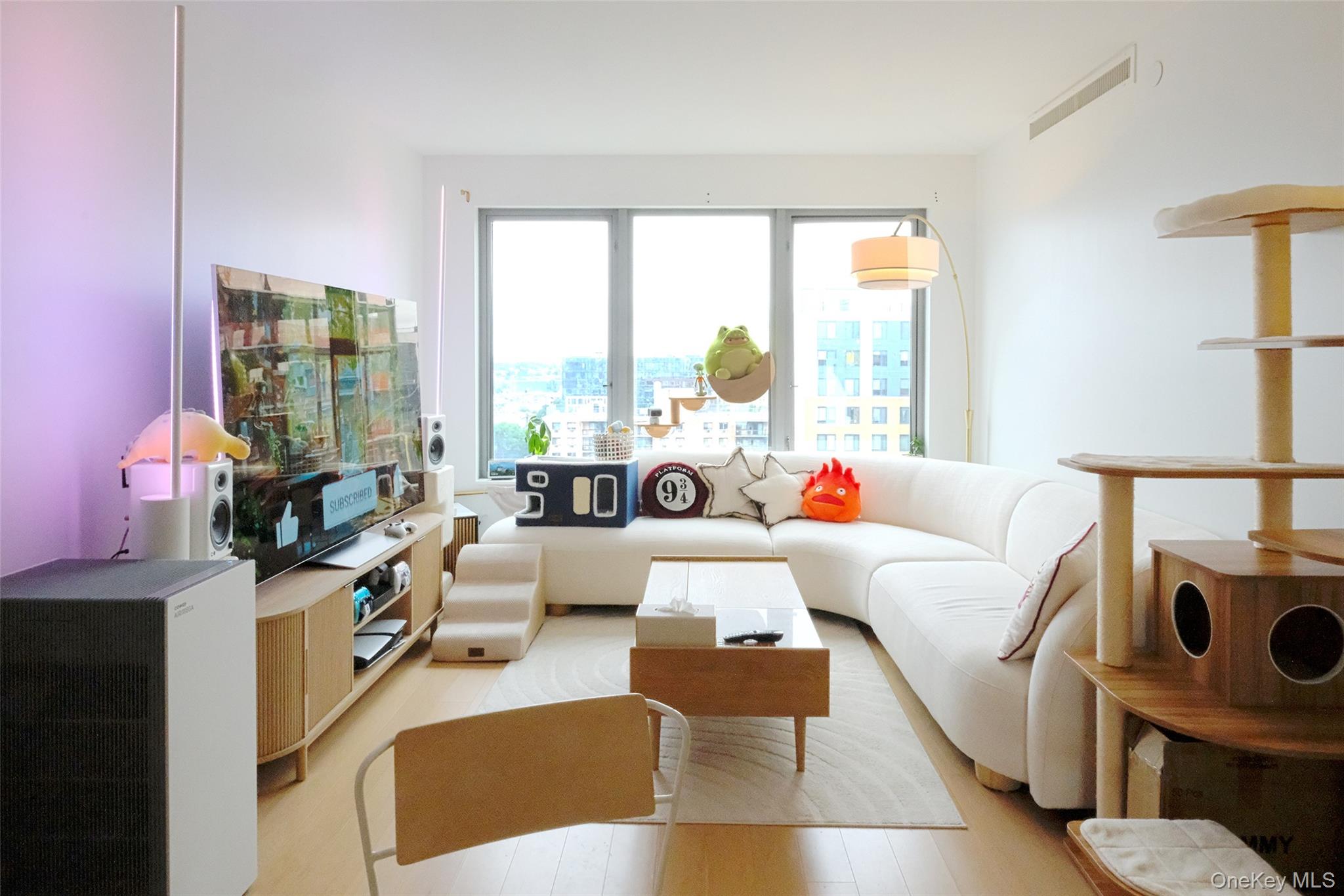 138-35 39th Avenue, Unit 12L Queens, NY 11354 - Photo 2 of 17 a living room with furniture and a large window