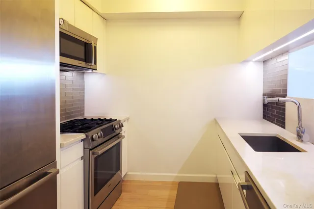 a kitchen with a sink and a stove top oven