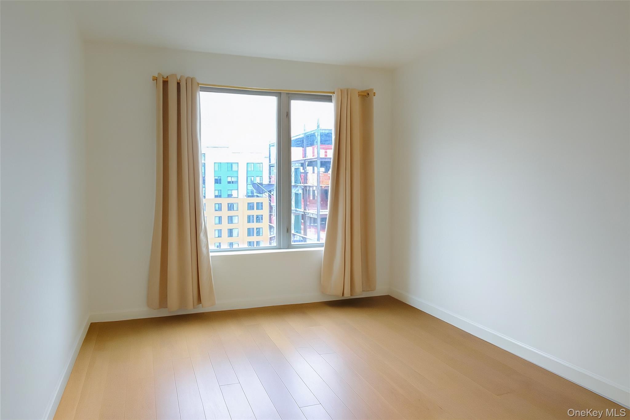138-35 39th Avenue, Unit 12L Queens, NY 11354 - Photo 6 of 17 an empty room with a window