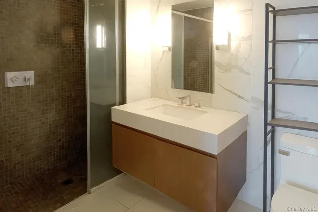 a utility room with a sink and a mirror