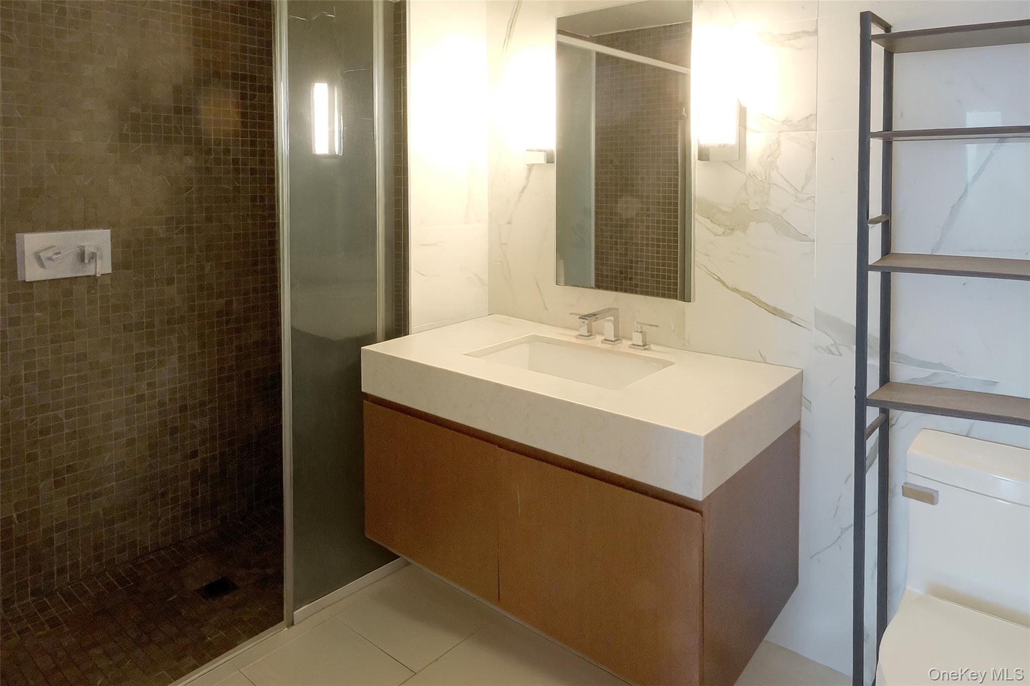 138-35 39th Avenue, Unit 12L Queens, NY 11354 - Photo 7 of 17 a utility room with a sink and a mirror