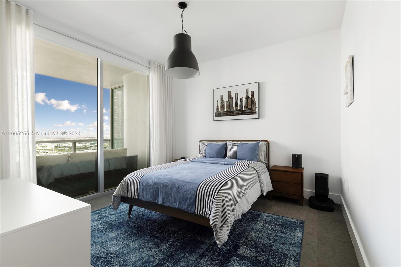 900 Biscayne Boulevard, Unit 3609 Miami, FL 33132 - Photo 12 of 36 a bedroom with a bed and a night stand