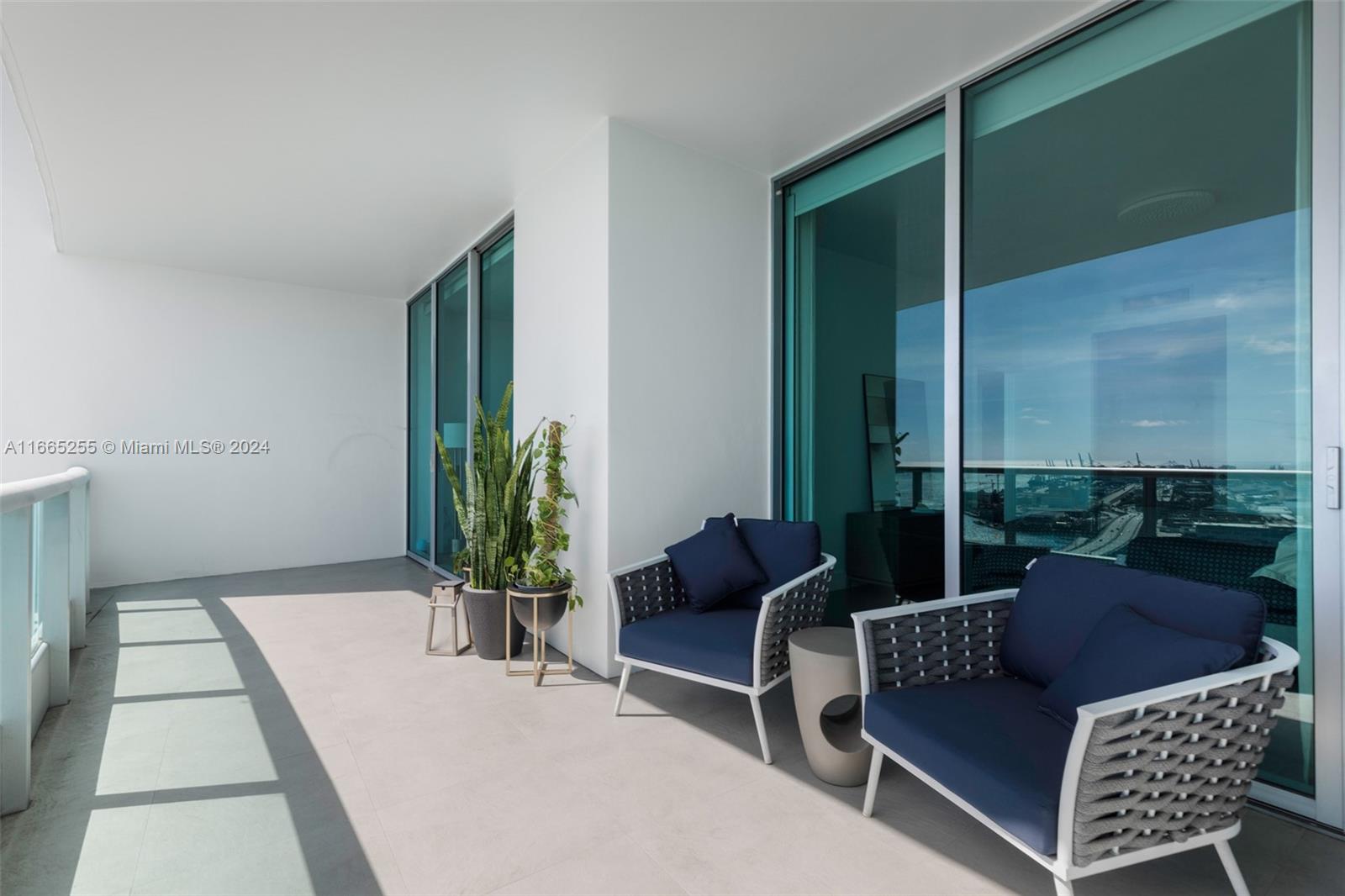 900 Biscayne Boulevard, Unit 3609 Miami, FL 33132 - Photo 21 of 36 a living room with furniture and a potted plant