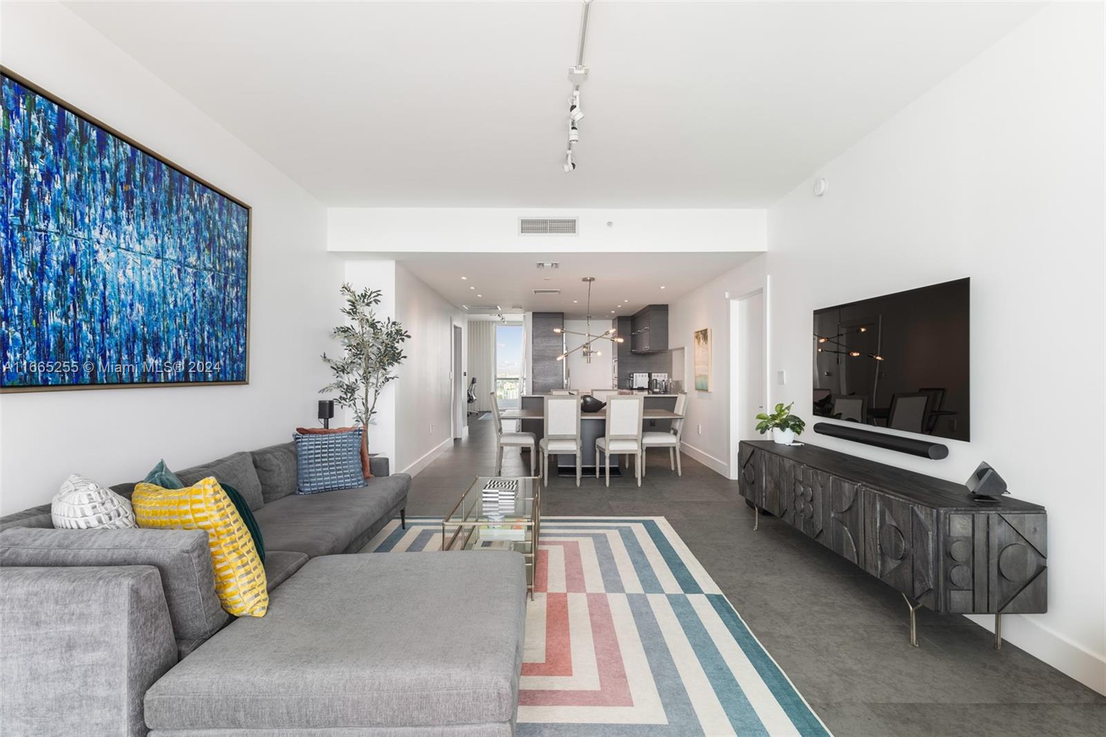 900 Biscayne Boulevard, Unit 3609 Miami, FL 33132 - Photo 3 of 36 a living room with furniture and a flat screen tv