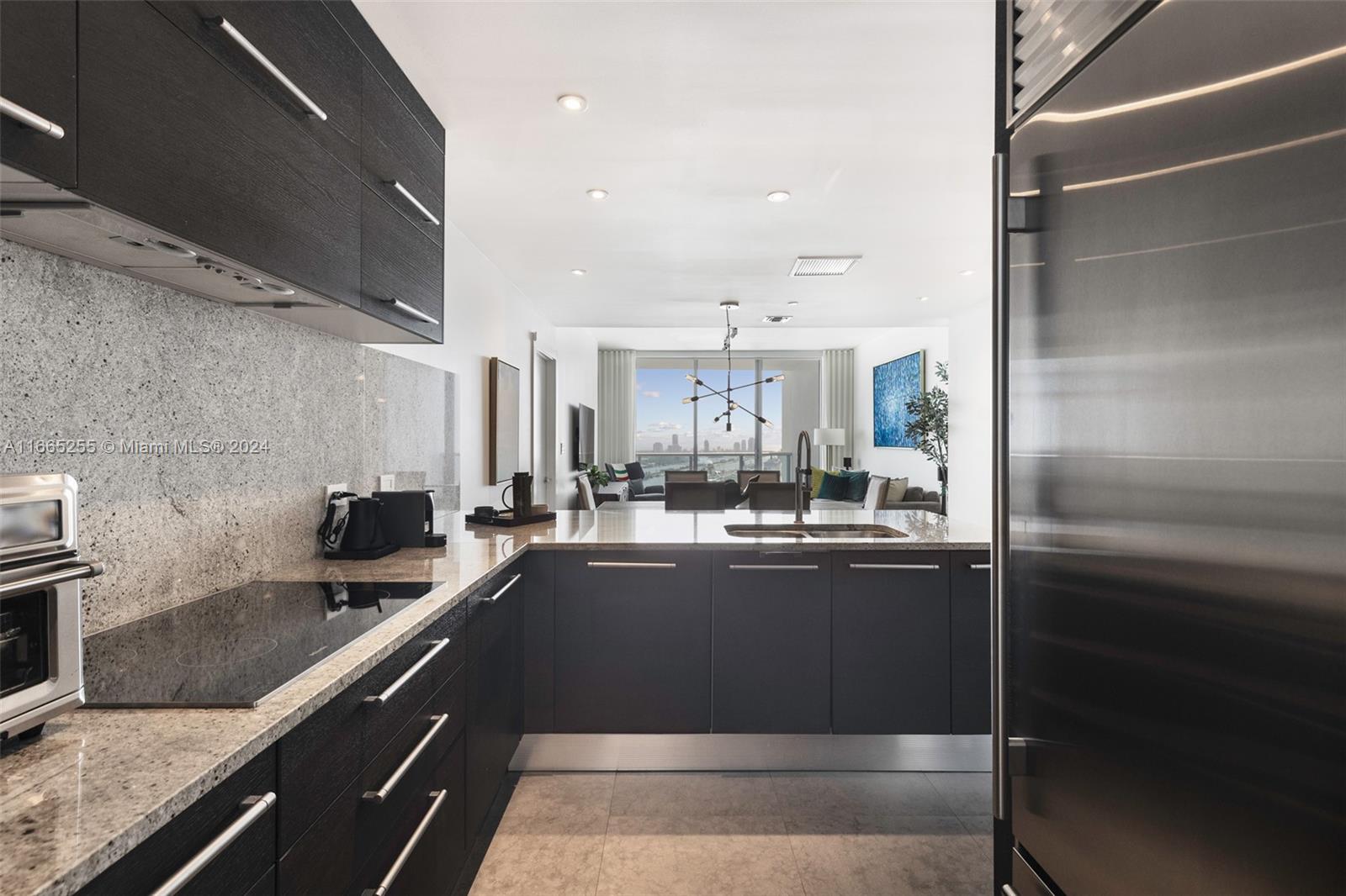 900 Biscayne Boulevard, Unit 3609 Miami, FL 33132 - Photo 6 of 36 a kitchen with a sink and stainless steel appliances