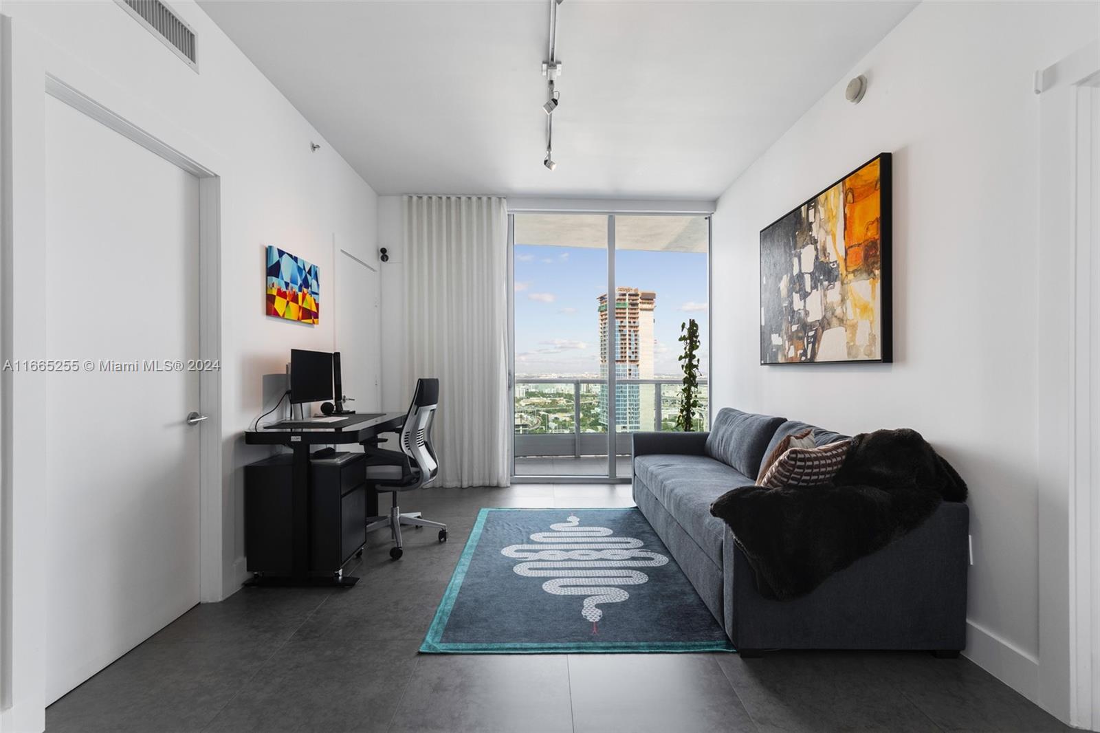 900 Biscayne Boulevard, Unit 3609 Miami, FL 33132 - Photo 10 of 36 a living room with furniture and a flat screen tv