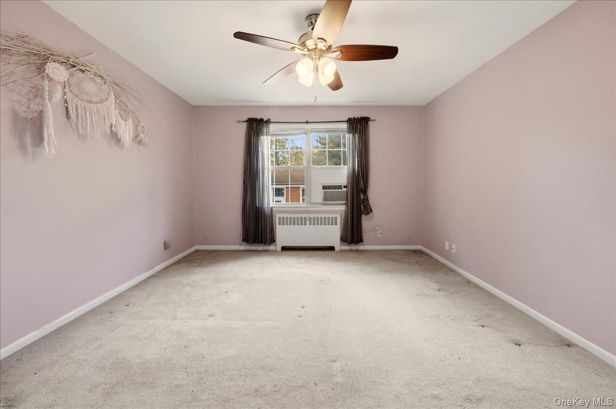 186 Pinewood Road, Unit 56 Hartsdale, NY 10530 - Photo 18 of 20 a view of an empty room with a window