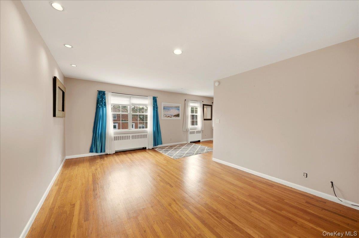 186 Pinewood Road, Unit 56 Hartsdale, NY 10530 - Photo 8 of 20 a view of an empty room with wooden floor and a window