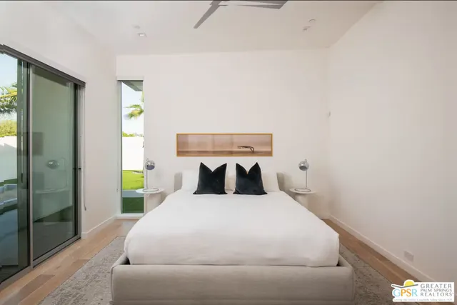 a large bed sitting in a bedroom next to a bathroom