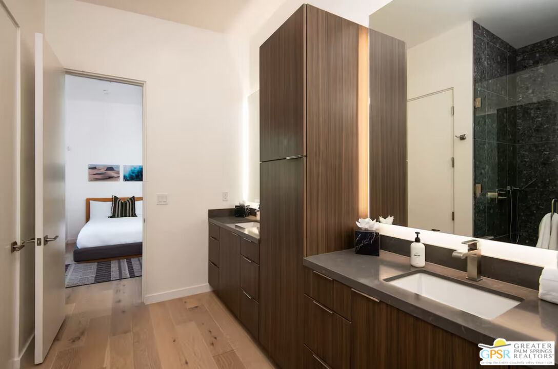89022 Elemento Lane Indio, CA 92201 - Photo 14 of 31 a en suite bathroom with a double vanity sink a mirror and a bathtub