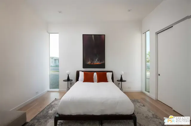 a bedroom with a bed and mirror