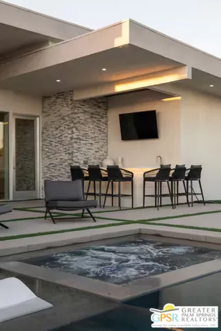 a living room with couches and a flat screen tv