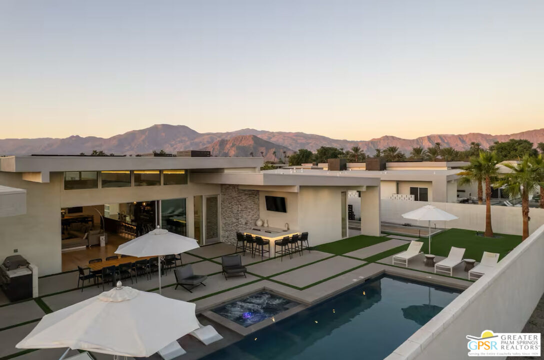 89022 Elemento Lane Indio, CA 92201 - Photo 24 of 31 a view of a patio with couches table and chairs with wooden floor barbeque and fence