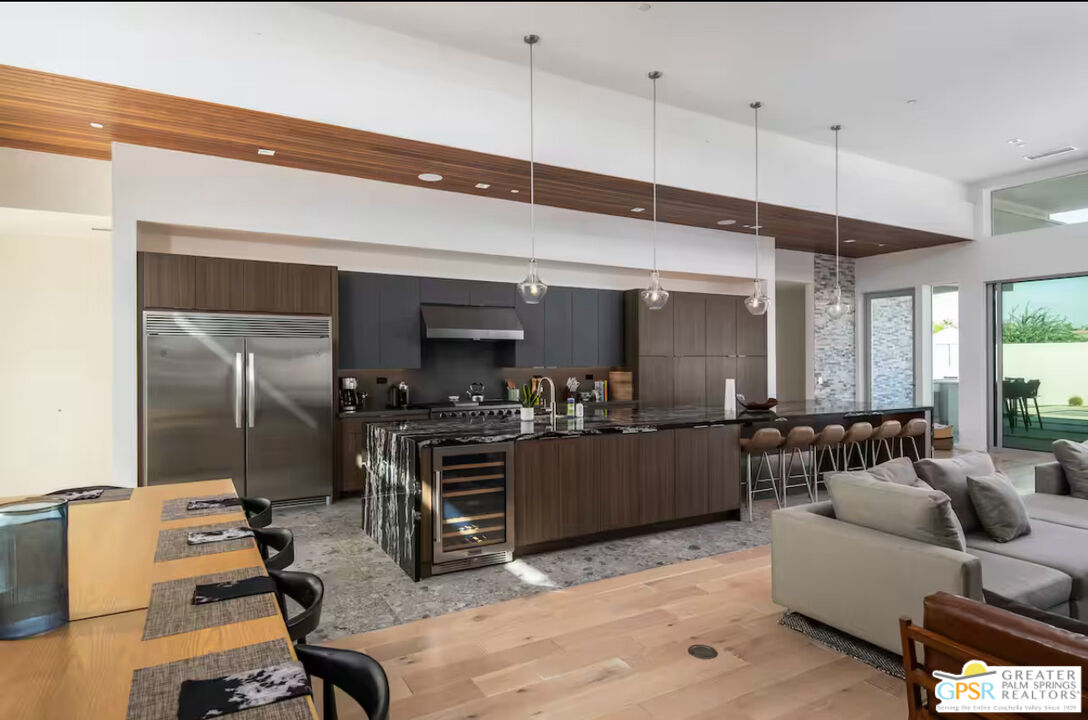 89022 Elemento Lane Indio, CA 92201 - Photo 3 of 31 a living room with furniture a flat screen tv and kitchen view