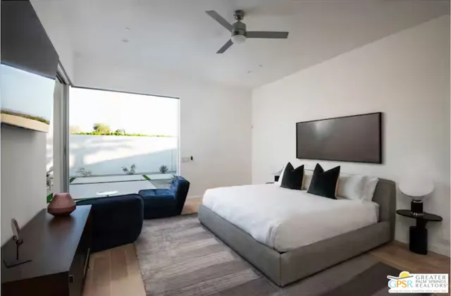 a bedroom with a bed window and a desk