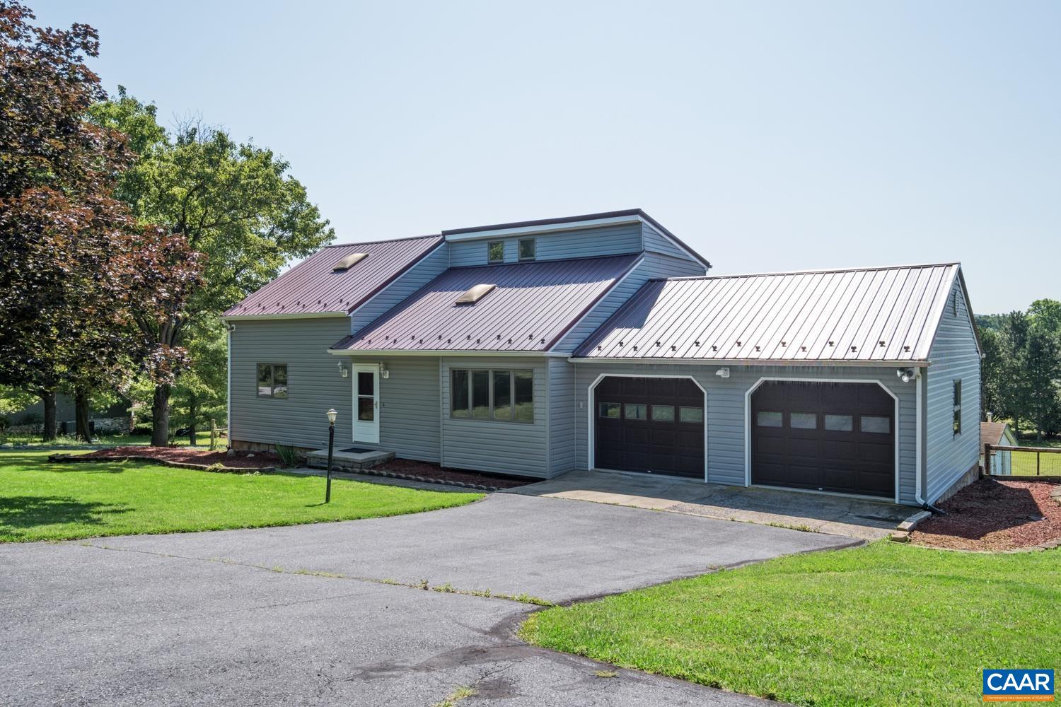 a front view of a house with a garden and yard