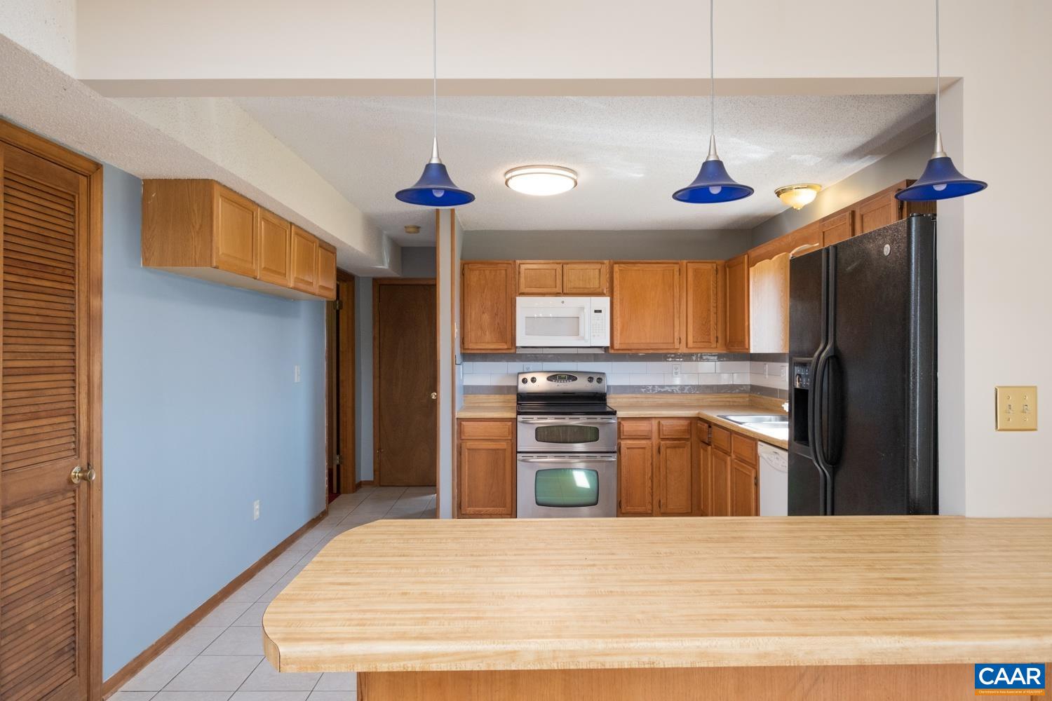 634 Augusta Farms Road Waynesboro, VA 22980 - Photo 14 of 32 a kitchen with stainless steel appliances kitchen island granite countertop a refrigerator and a stove top oven