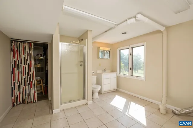 a view of a hallway with bathroom and glass door