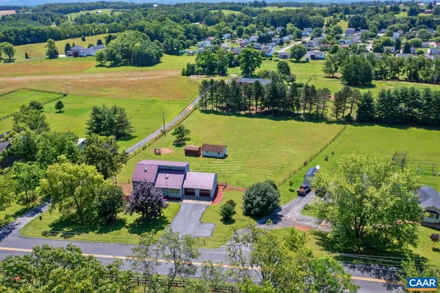 an aerial view of house with yard swimming pool and outdoor seating