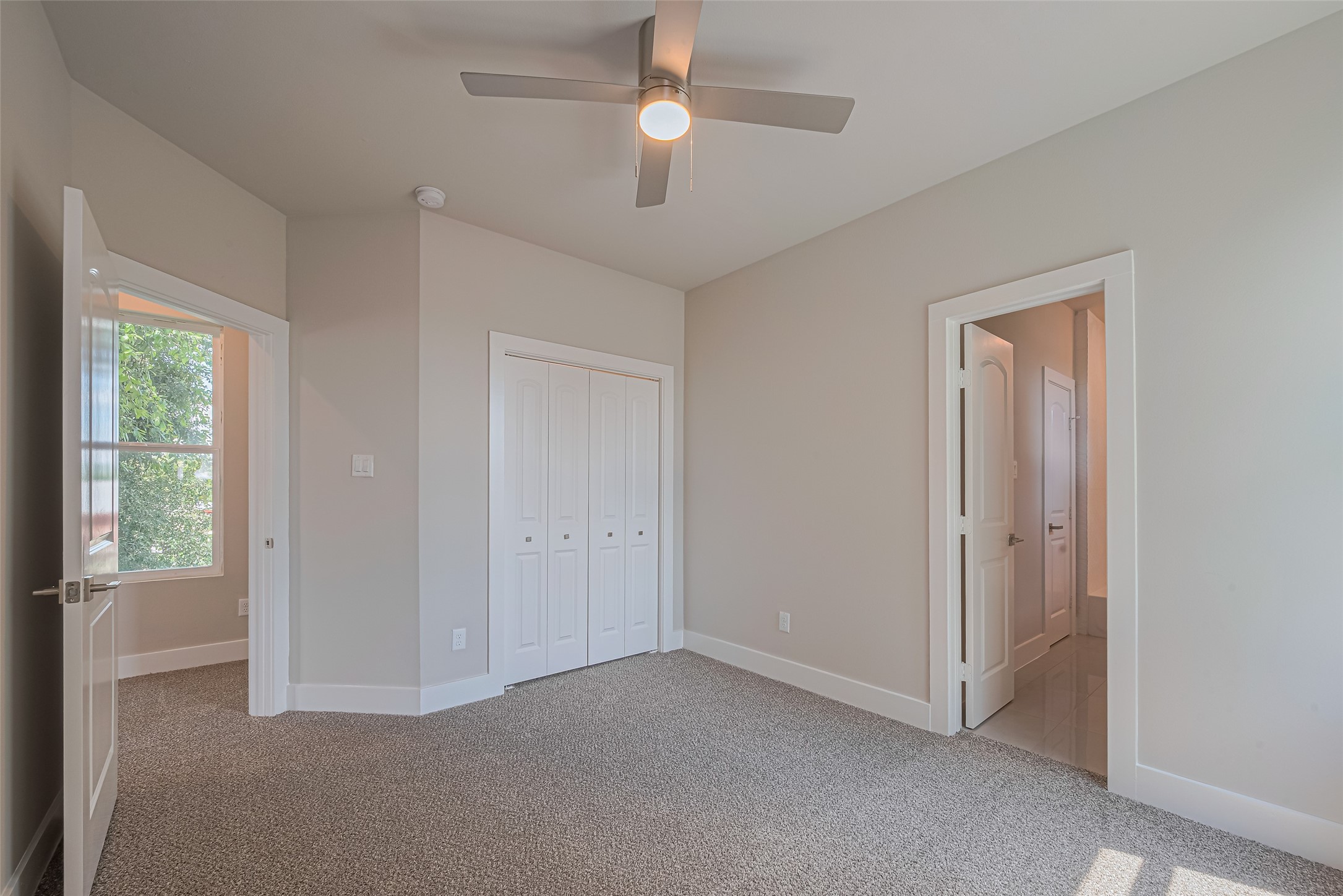 7207 Force Street Houston, TX 77020 - Photo 17 of 29 It includes a closet with double doors and has ample natural light from a window. There's a door leading to an adjacent hallway or room.