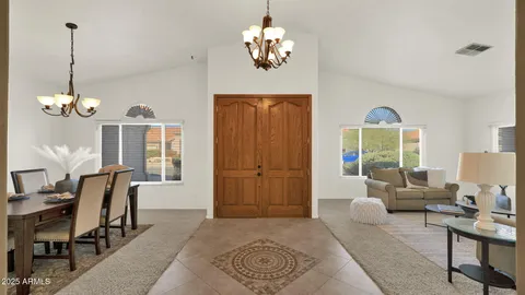 a living room with furniture a rug and a window