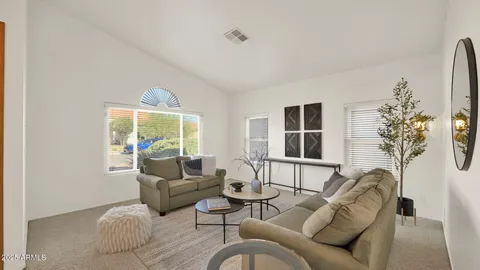 a dining room with furniture a chandelier and window